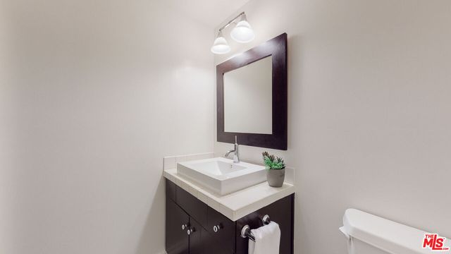 a bathroom with a sink vanity and a mirror
