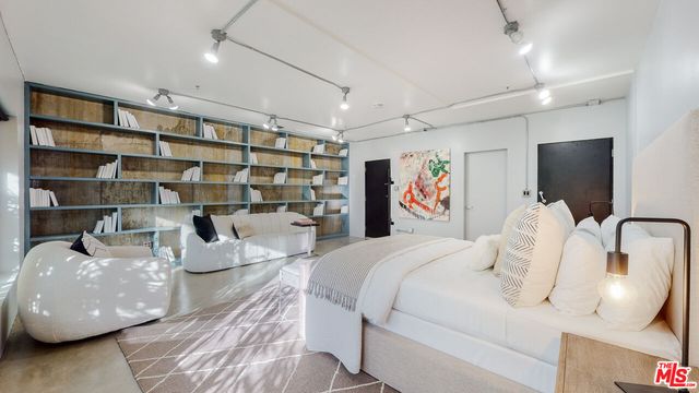 a bedroom with a bed and furniture