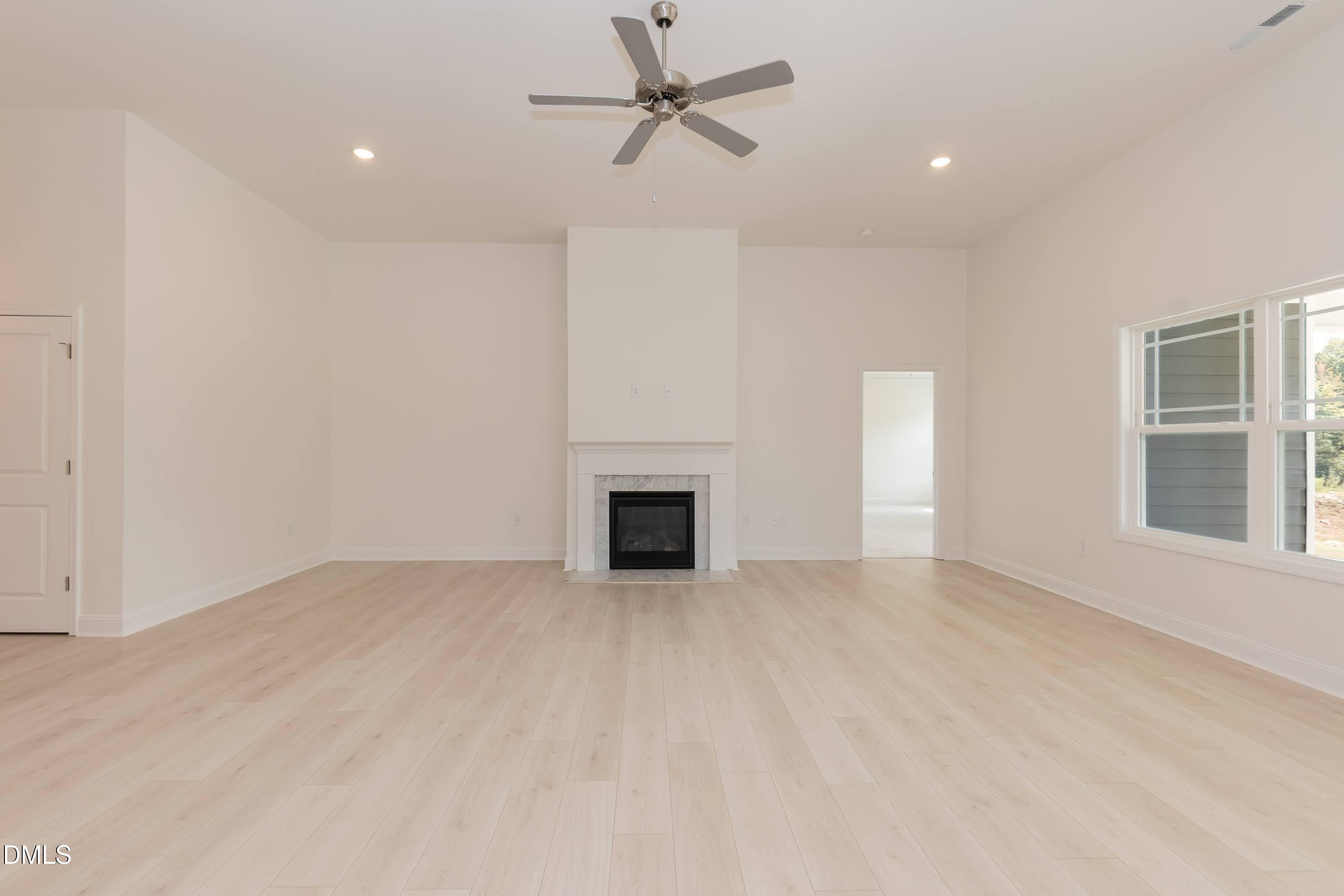 254 Galway Road Lillington, NC 27546 - Photo 8 of 35 an empty room with windows and a fireplace