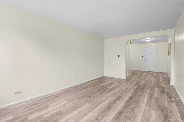 a view of an empty room and wooden floor