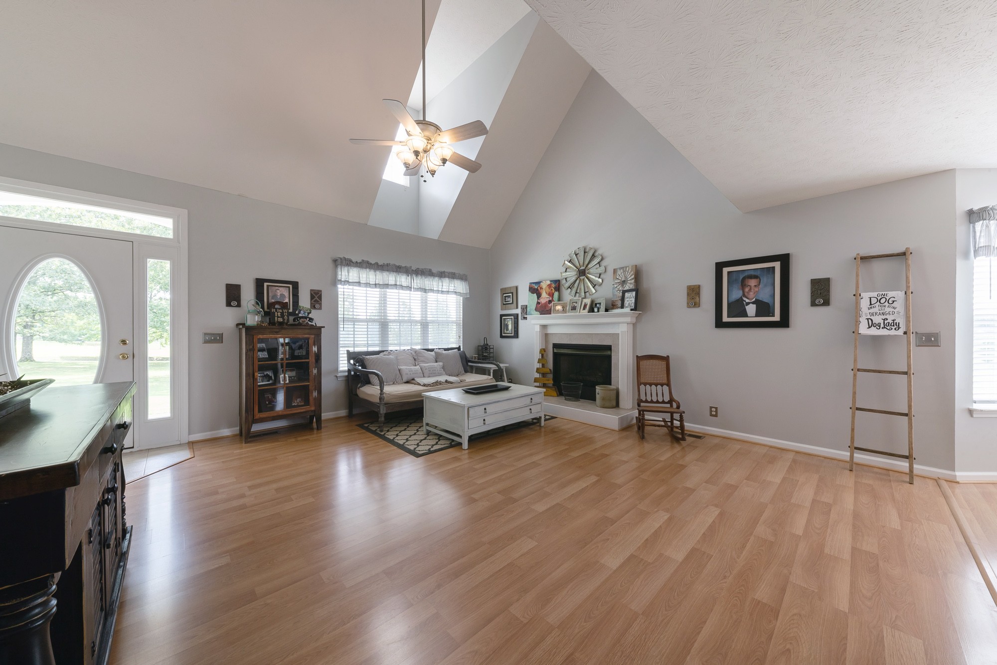 1678 Porter Road Bon Aqua, TN 37025 - Photo 20 of 36 a view of a livingroom with furniture a flat screen tv and staircase