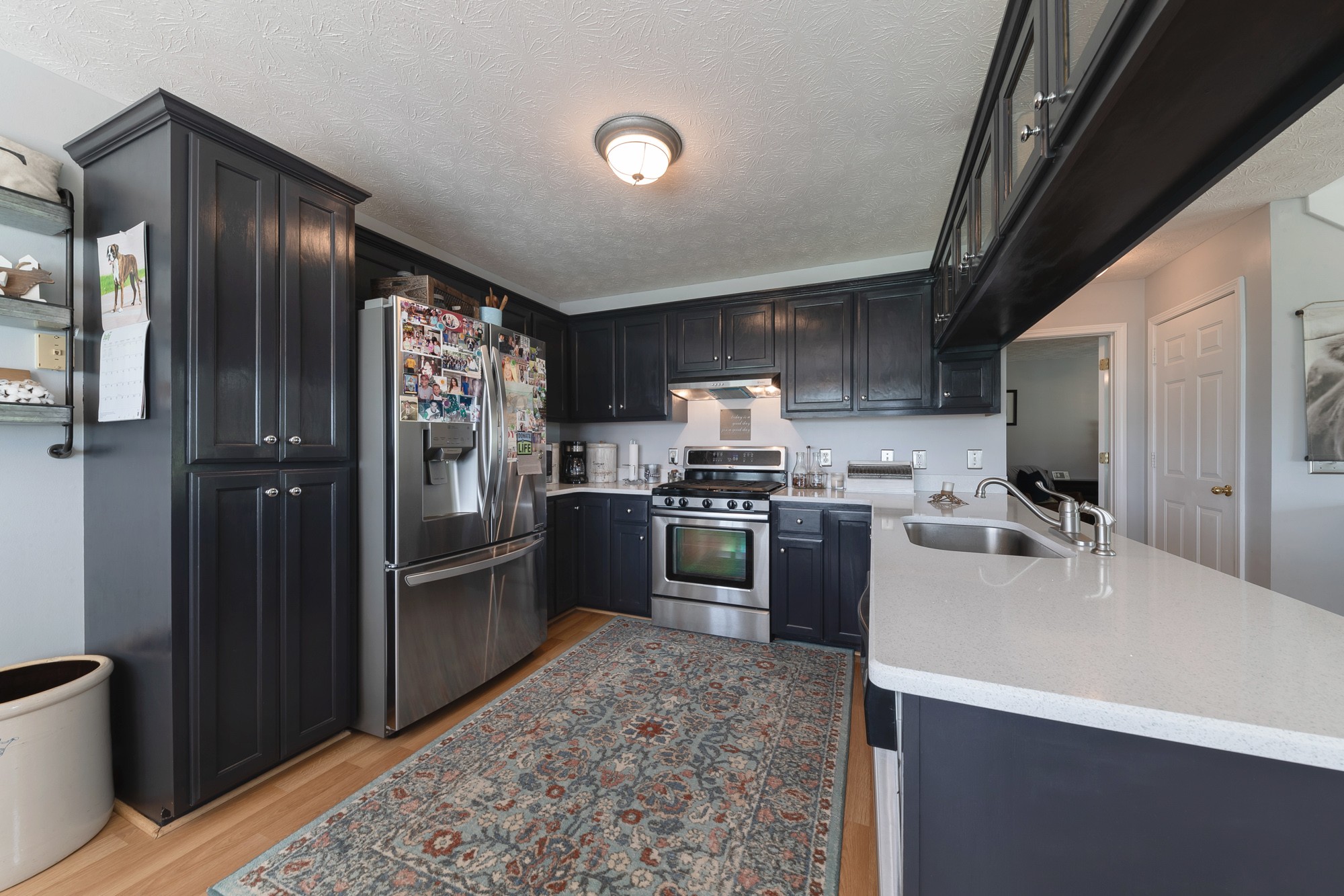 1678 Porter Road Bon Aqua, TN 37025 - Photo 23 of 36 a kitchen with refrigerator cabinets and stainless steel appliances