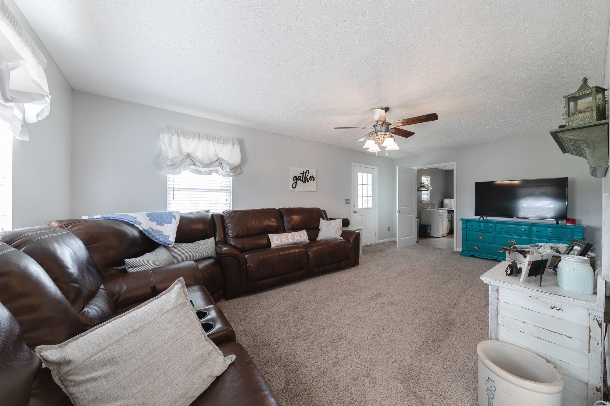 1678 Porter Road Bon Aqua, TN 37025 - Photo 26 of 36 a living room with furniture a flat screen tv and a window