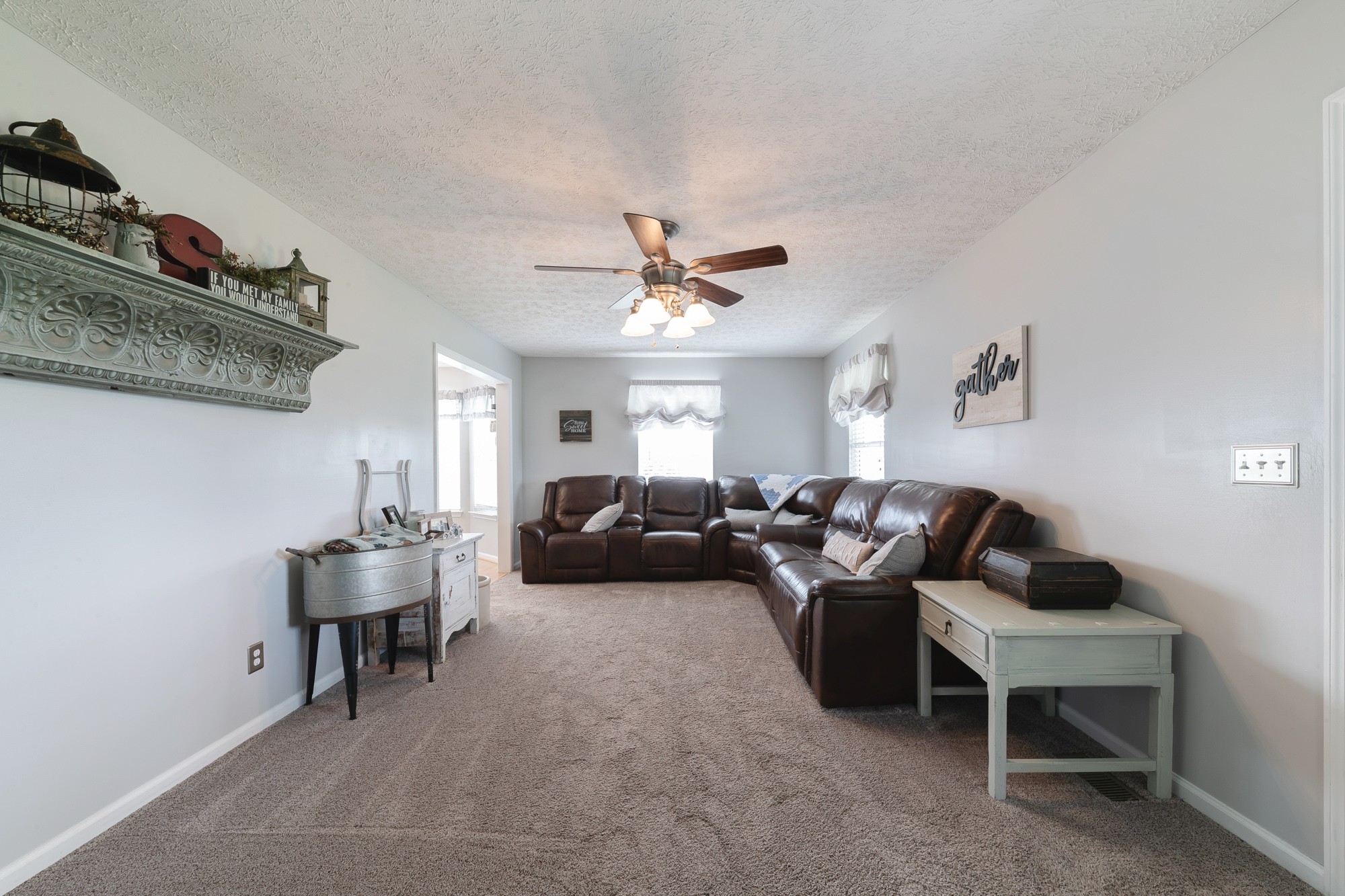 1678 Porter Road Bon Aqua, TN 37025 - Photo 27 of 36 a living room with furniture and a ceiling fan