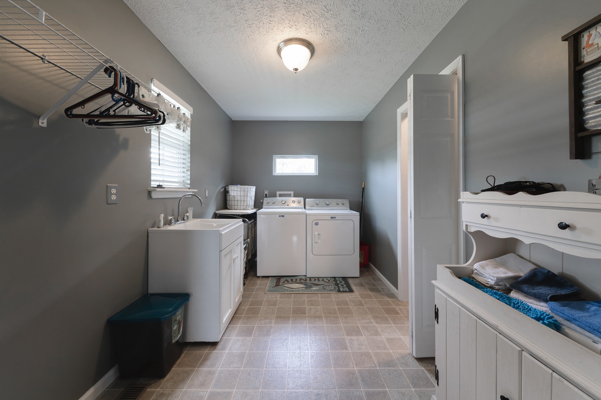 1678 Porter Road Bon Aqua, TN 37025 - Photo 28 of 36 a utility room with a sink a washer and dryer