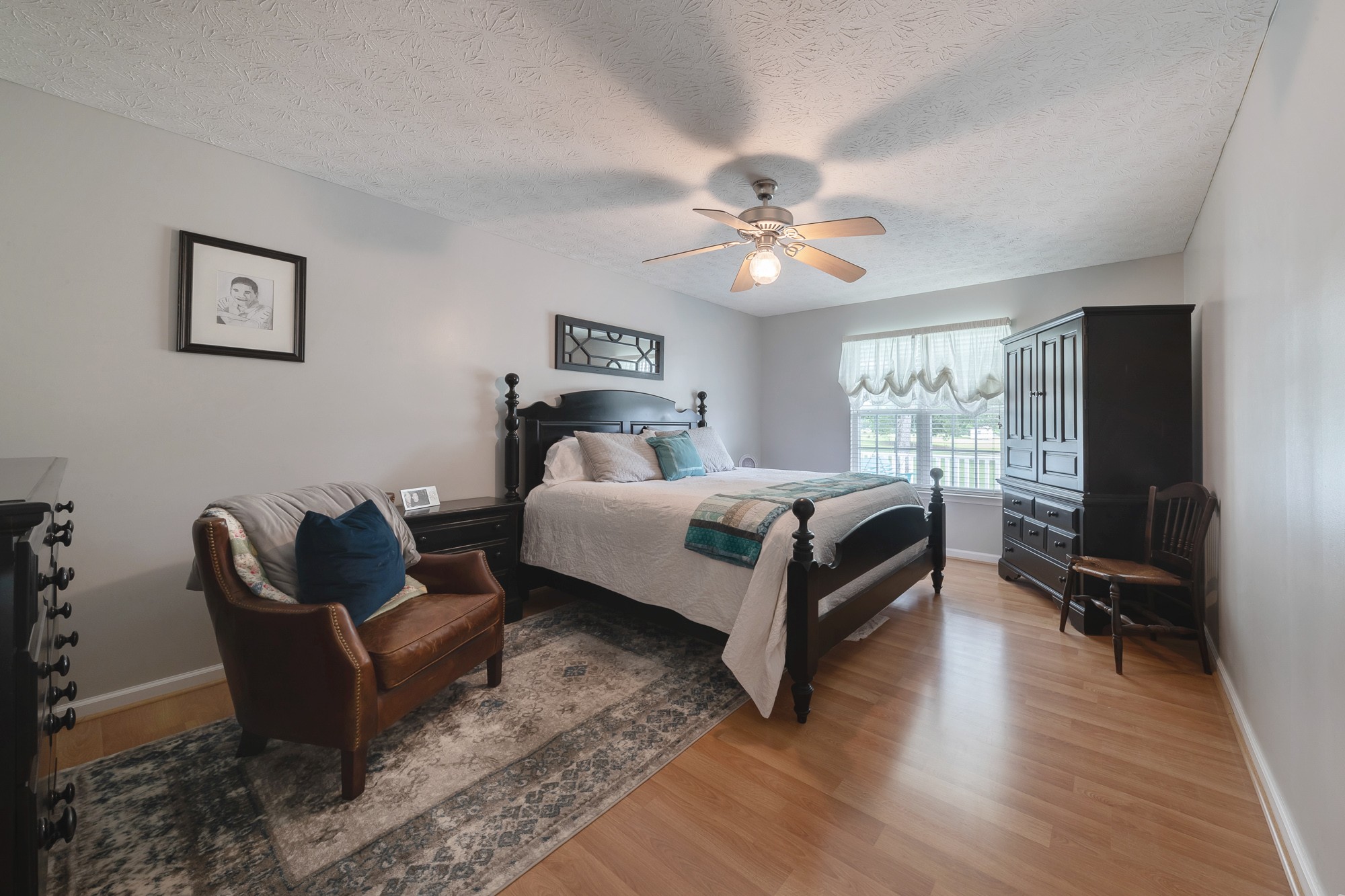 1678 Porter Road Bon Aqua, TN 37025 - Photo 30 of 36 a bedroom with a bed couch and a window