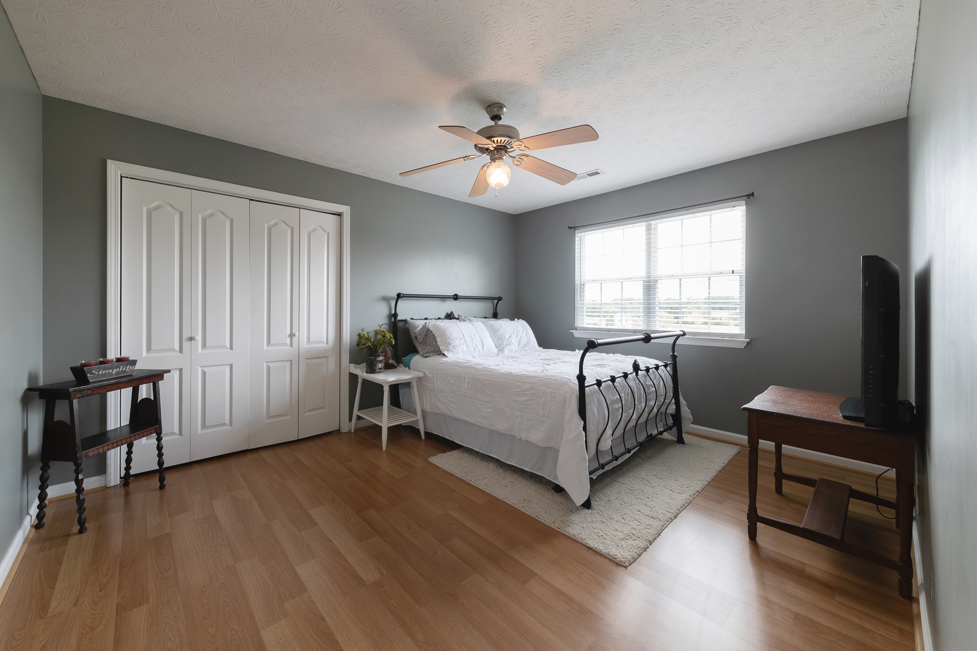 1678 Porter Road Bon Aqua, TN 37025 - Photo 33 of 36 a bedroom with a bed and a table in it