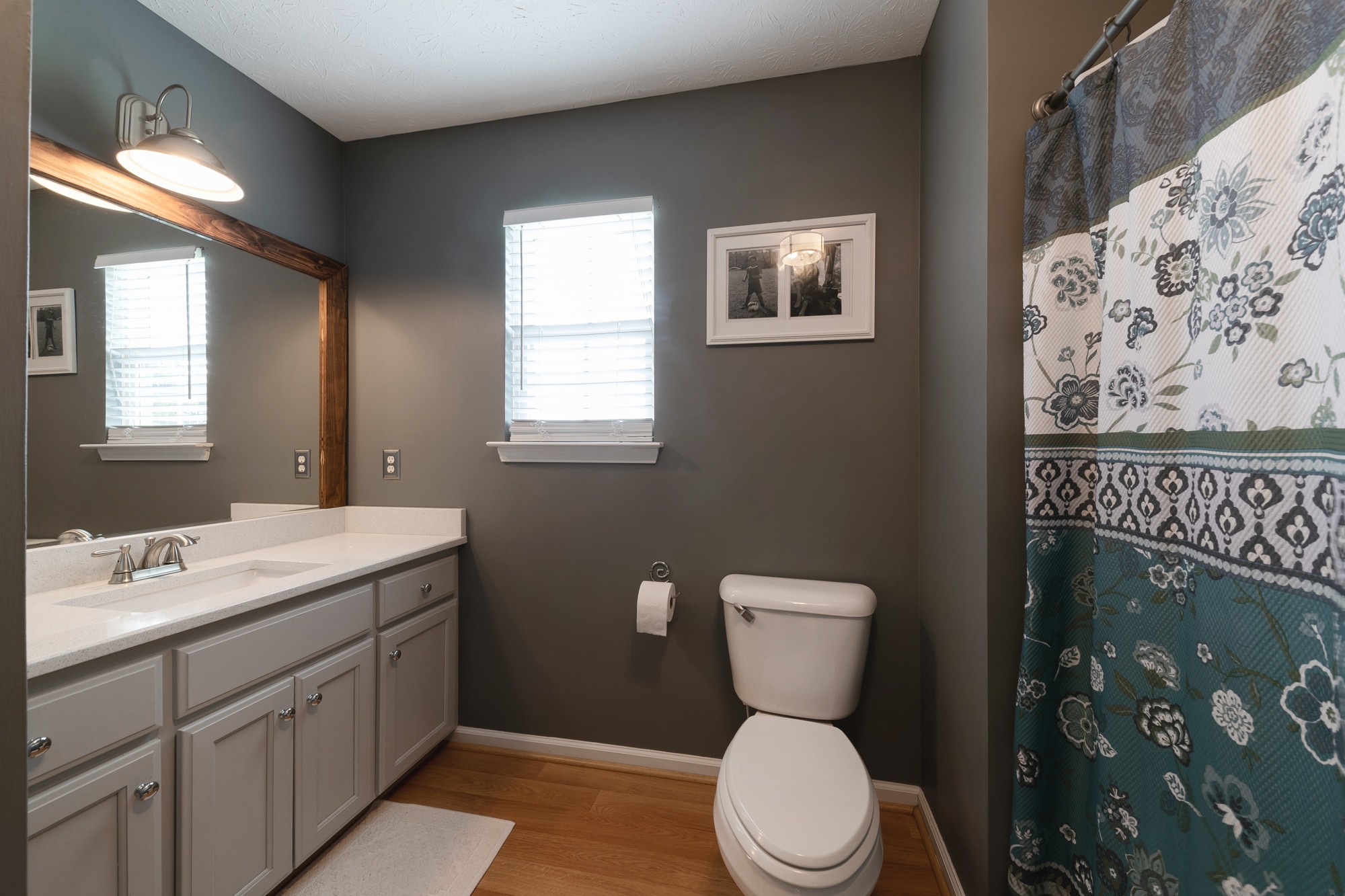 1678 Porter Road Bon Aqua, TN 37025 - Photo 34 of 36 a bathroom with a toilet sink and mirror
