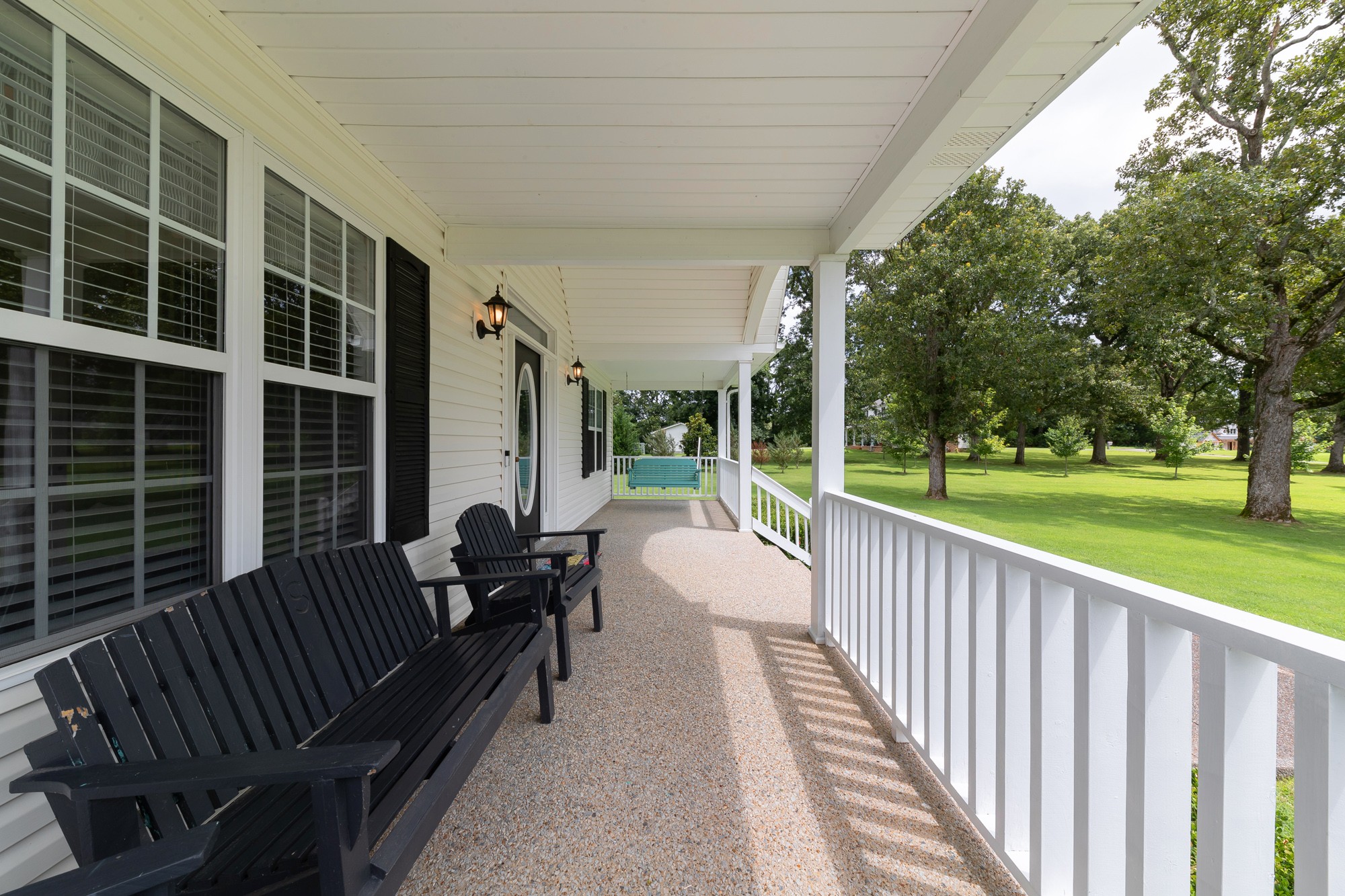 1678 Porter Road Bon Aqua, TN 37025 - Photo 7 of 36 a view of a deck with two couches and deck with wooden floor and fence