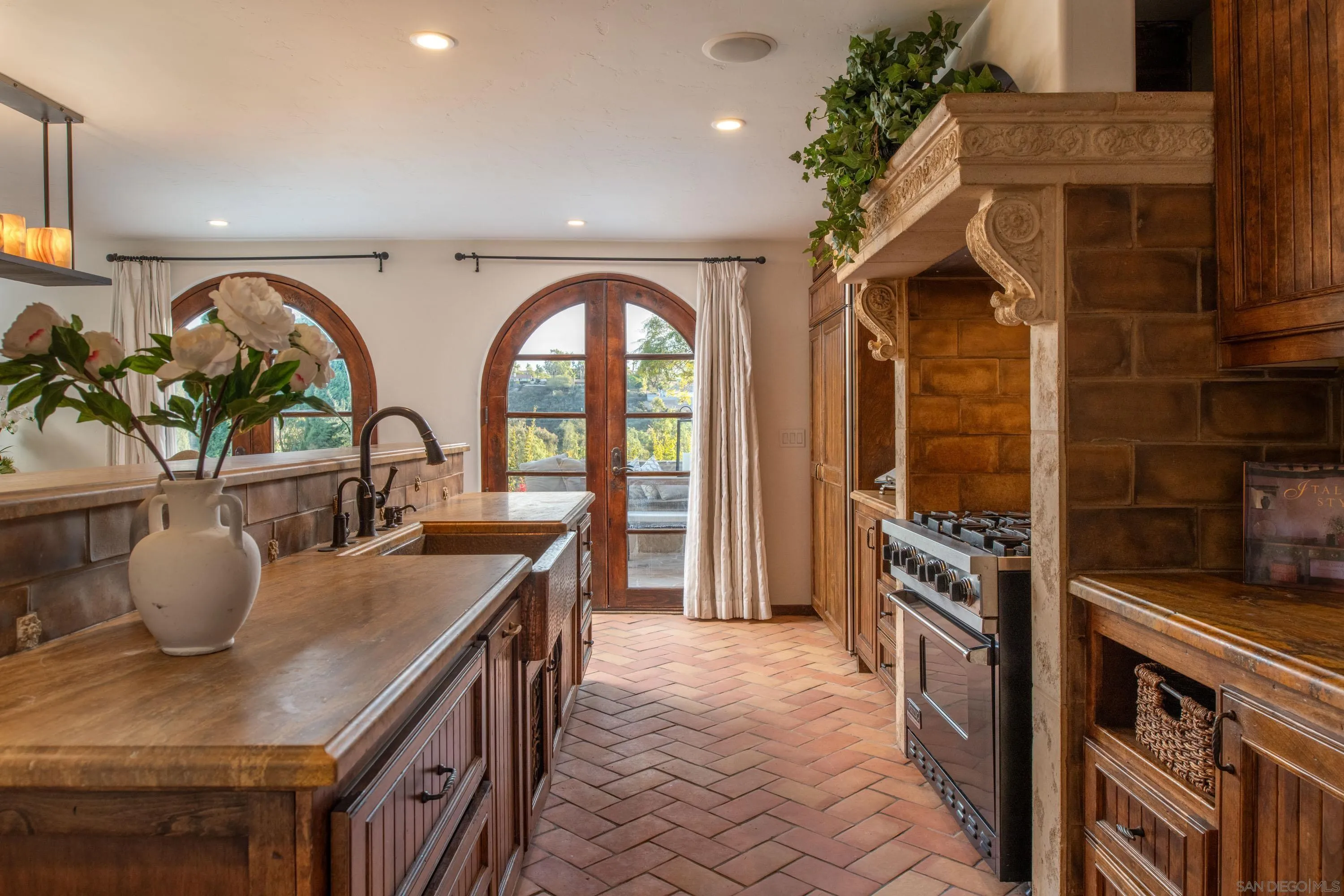 6511 Poco Lago Rancho Santa Fe, CA 92067 - Photo 6 of 24 a kitchen with stainless steel appliances granite countertop a stove a sink and a refrigerator