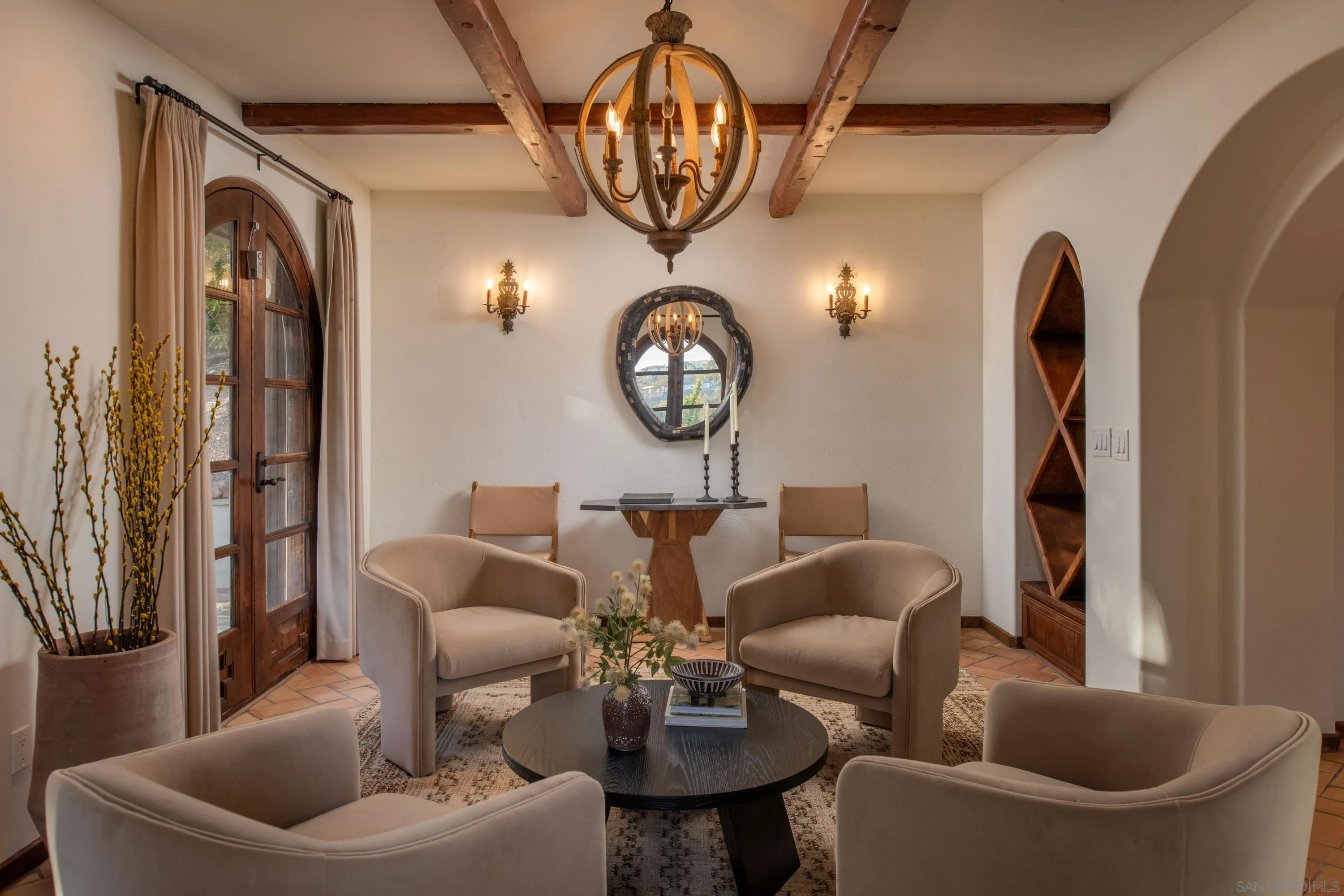 6511 Poco Lago Rancho Santa Fe, CA 92067 - Photo 9 of 24 a living room with furniture a chandelier a mirror and a fireplace
