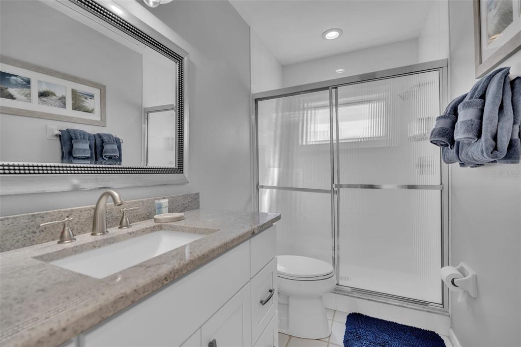 848 Evergreen Way Longboat Key, FL 34228 - Photo 22 of 66 a bathroom with a granite countertop sink mirror vanity and toilet