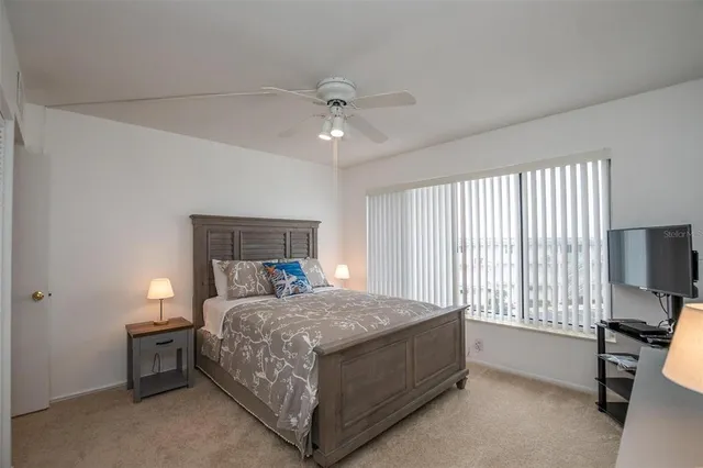 a bedroom with a bed and a tv on table