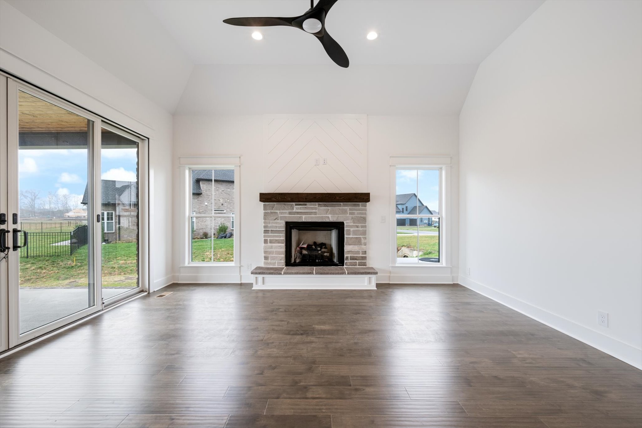 2631 Holly Spring Drive Murfreesboro, TN 37128 - Photo 8 of 33 a view of an empty room with wooden floor fireplace and a window