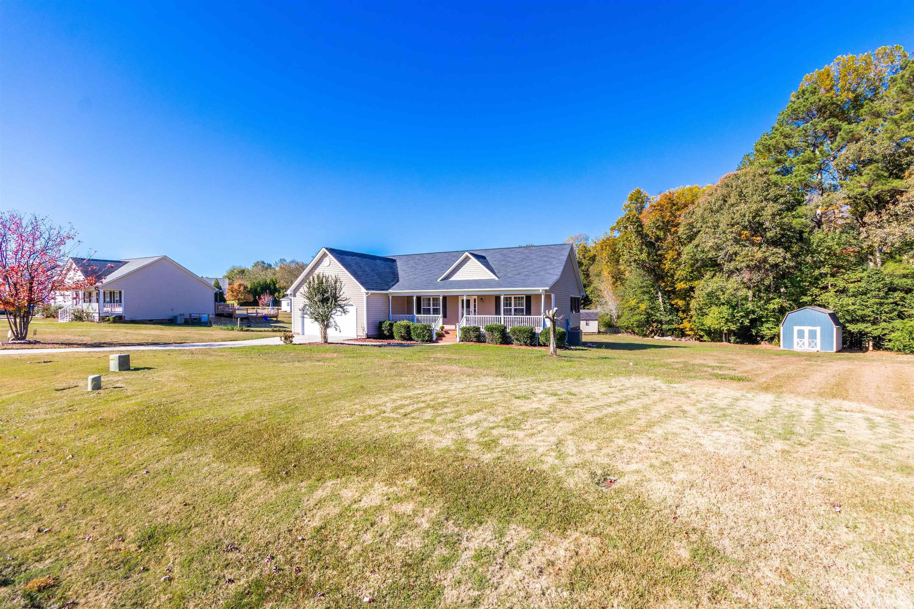 519 Axum Road Willow Spring, NC 27592 - Photo 2 of 30 a view of house with outdoor space and sitting area