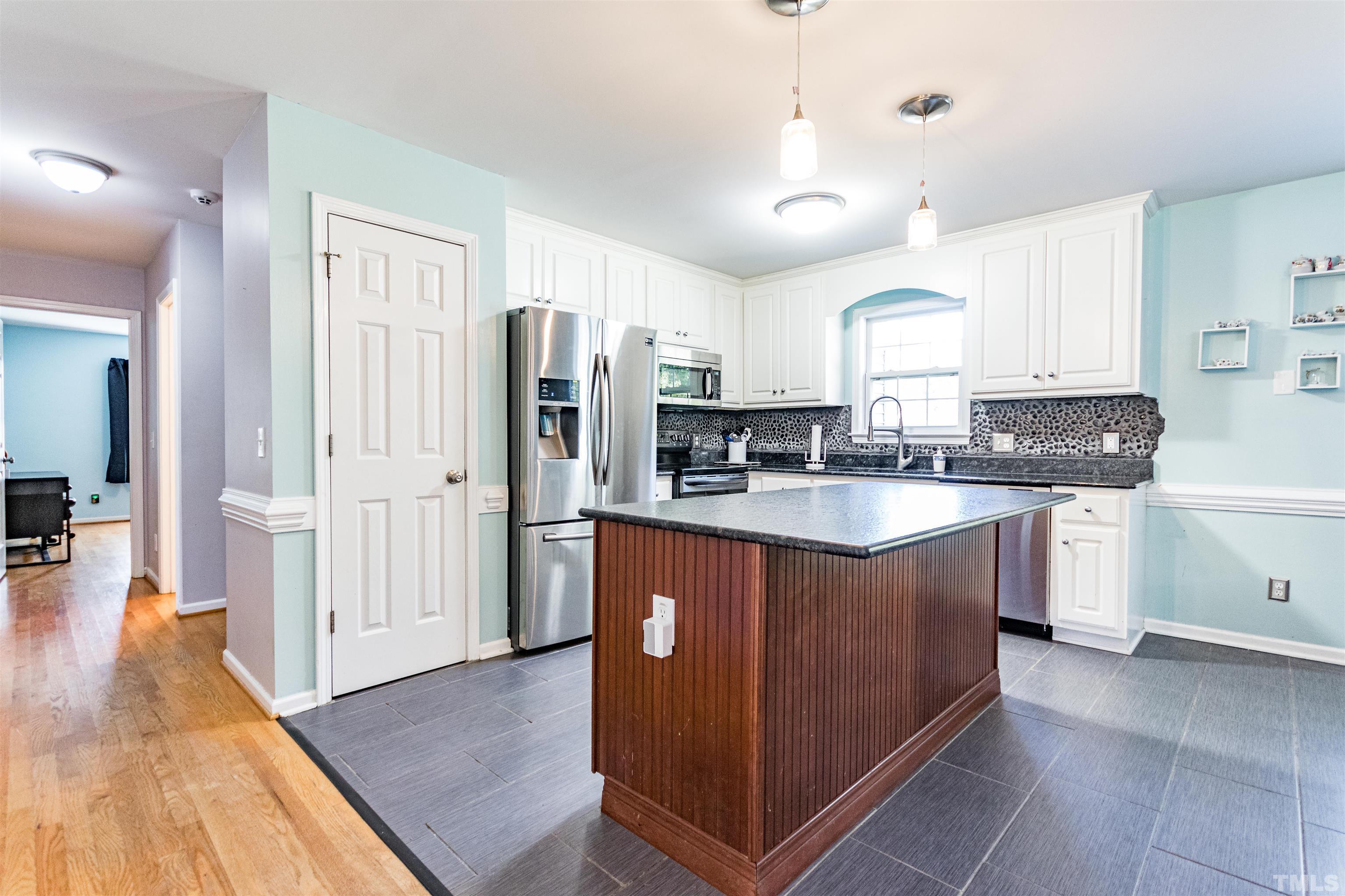 519 Axum Road Willow Spring, NC 27592 - Photo 13 of 30 a kitchen with stainless steel appliances granite countertop a refrigerator a sink a stove a microwave and island