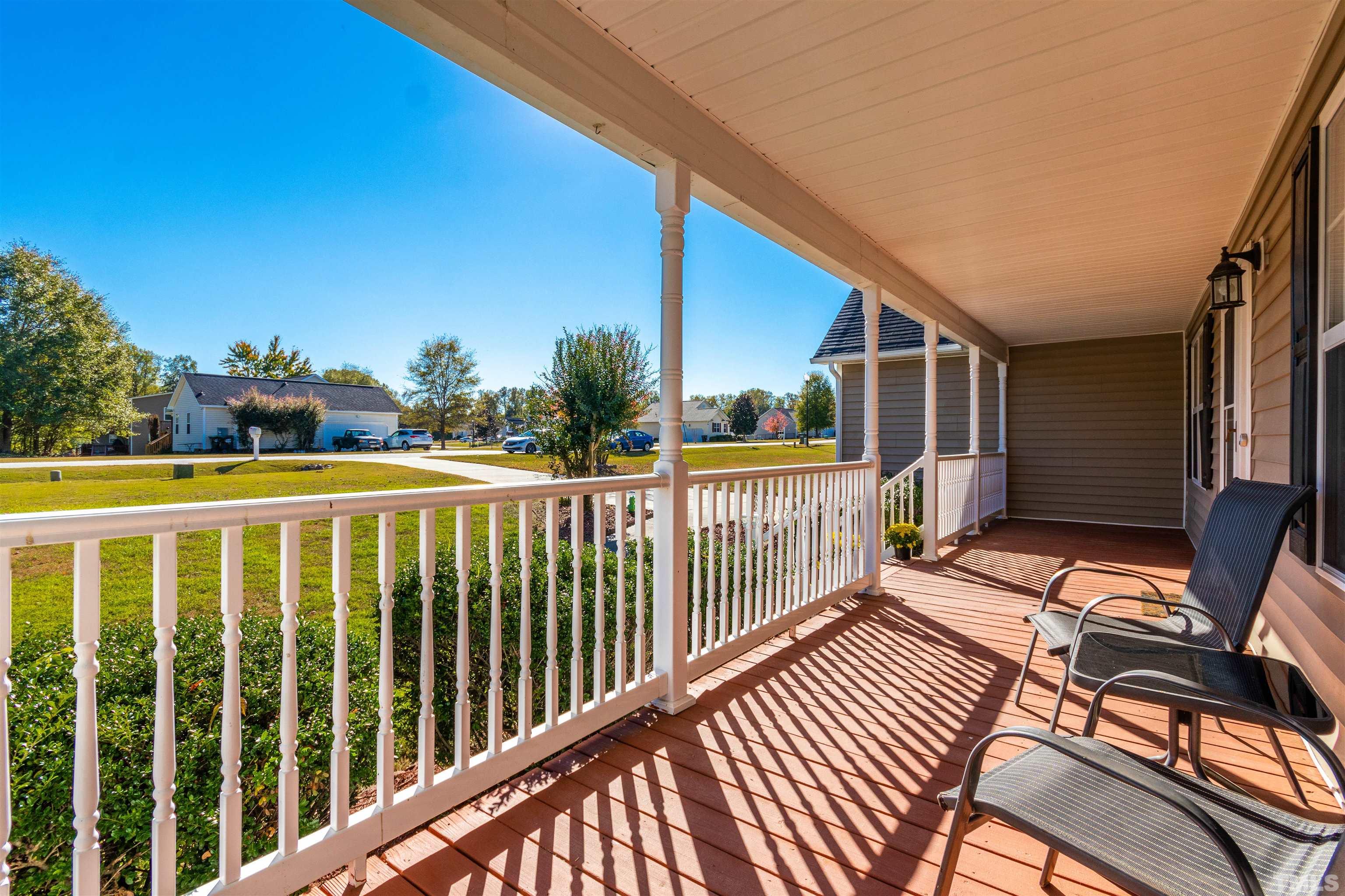 519 Axum Road Willow Spring, NC 27592 - Photo 3 of 30 a view of a balcony with wooden floor and outdoor seating