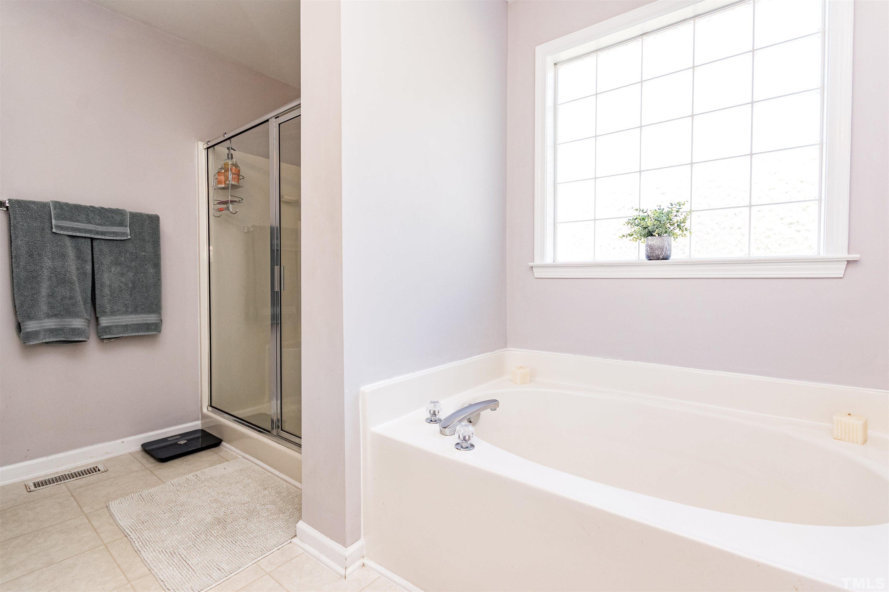 519 Axum Road Willow Spring, NC 27592 - Photo 21 of 30 a white bath tub sitting next to a window
