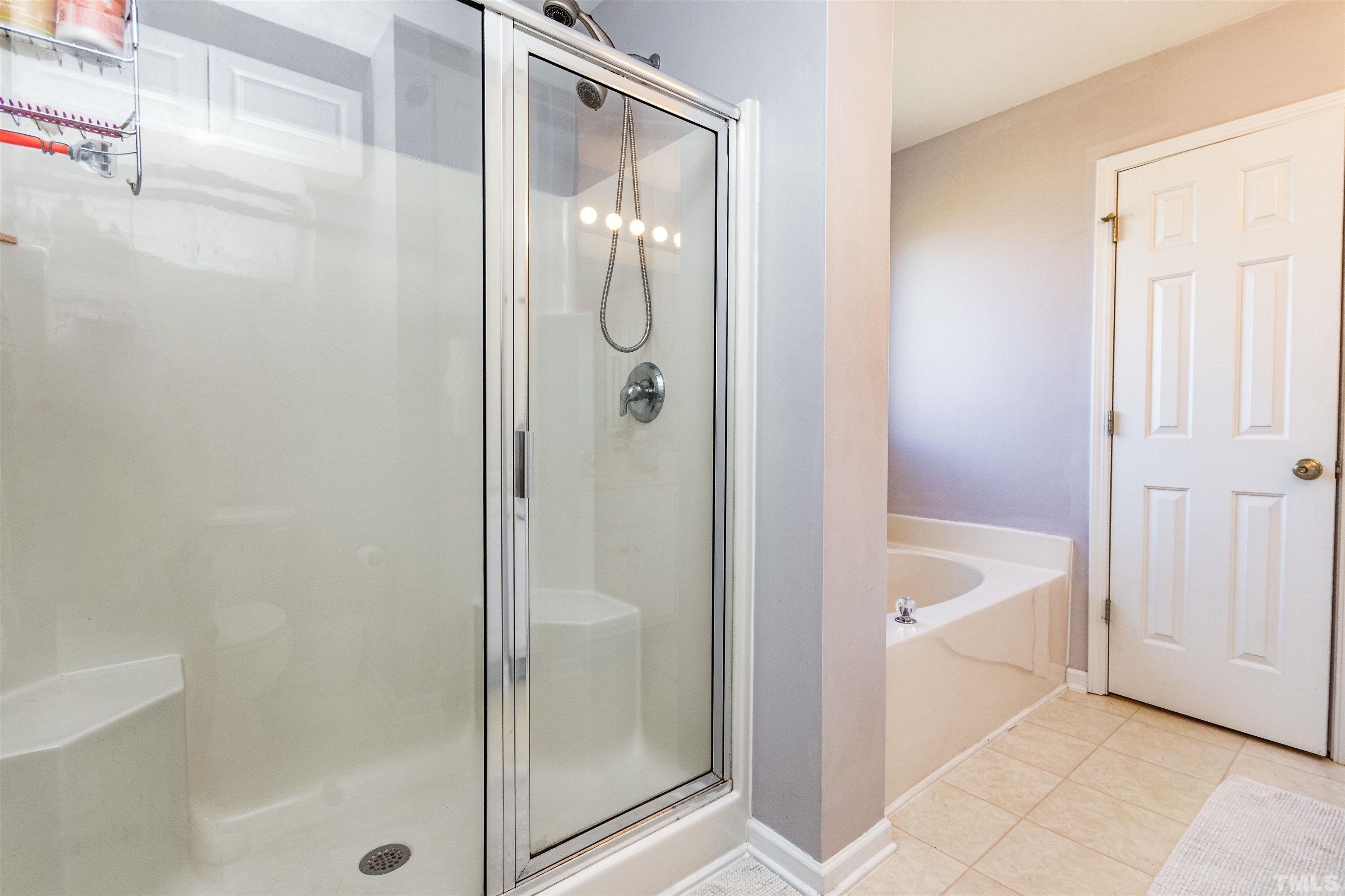 519 Axum Road Willow Spring, NC 27592 - Photo 22 of 30 a bathroom with a shower and a bath tub