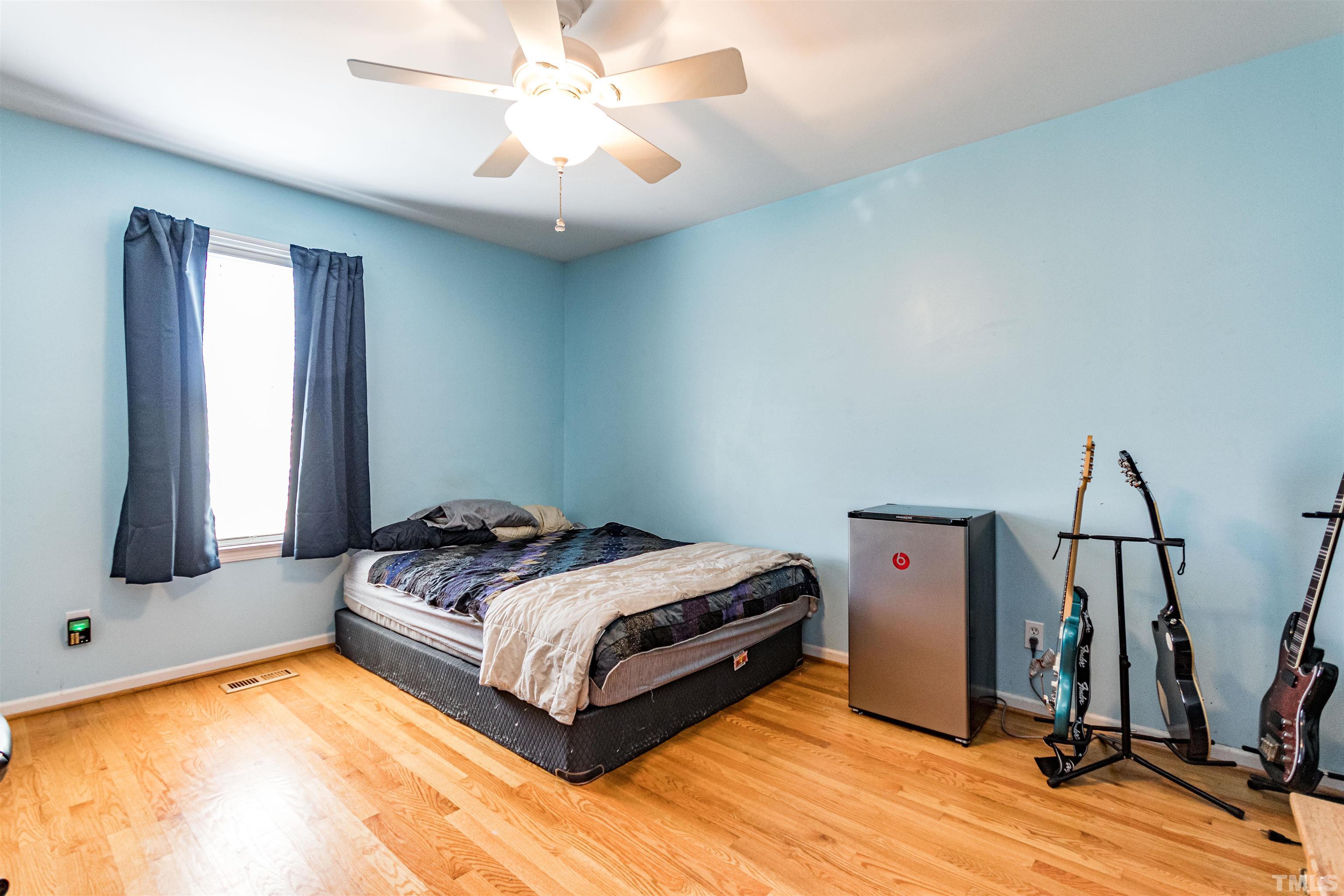 519 Axum Road Willow Spring, NC 27592 - Photo 24 of 30 a bedroom with a bed and a flat tv screen on the dresser