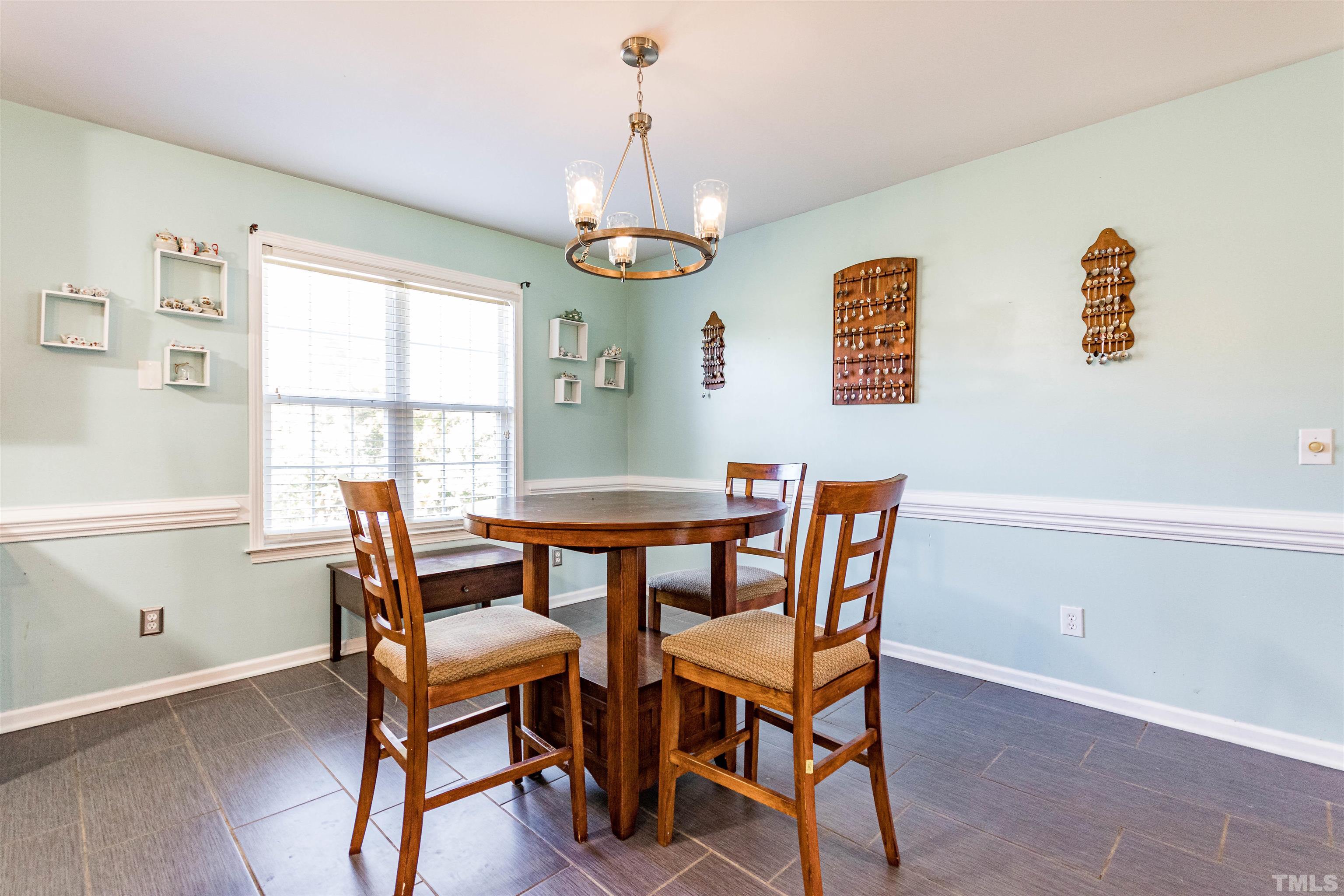 519 Axum Road Willow Spring, NC 27592 - Photo 8 of 30 a dining room with a wooden table and chairs
