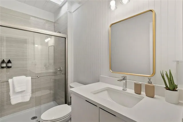 a bathroom with a sink toilet and shower