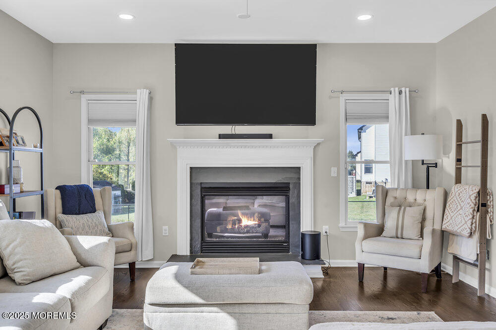 11 Cutter Court Cream Ridge, NJ 08514 - Photo 26 of 87 a living room with furniture a flat screen tv and a fireplace