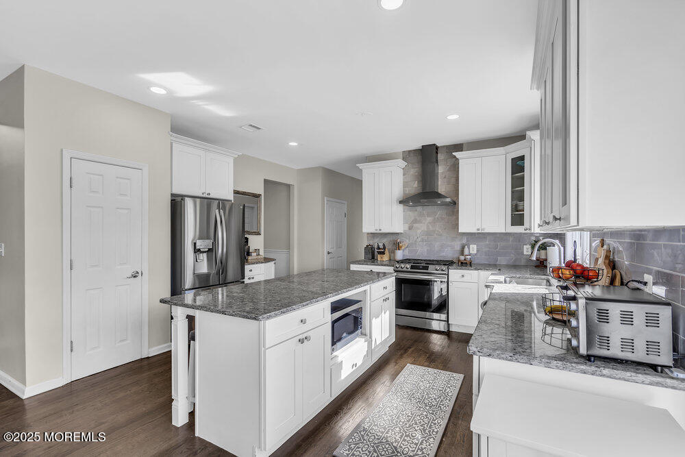 11 Cutter Court Cream Ridge, NJ 08514 - Photo 36 of 87 a large kitchen with stainless steel appliances granite countertop a stove a sink dishwasher and a refrigerator with wooden floor