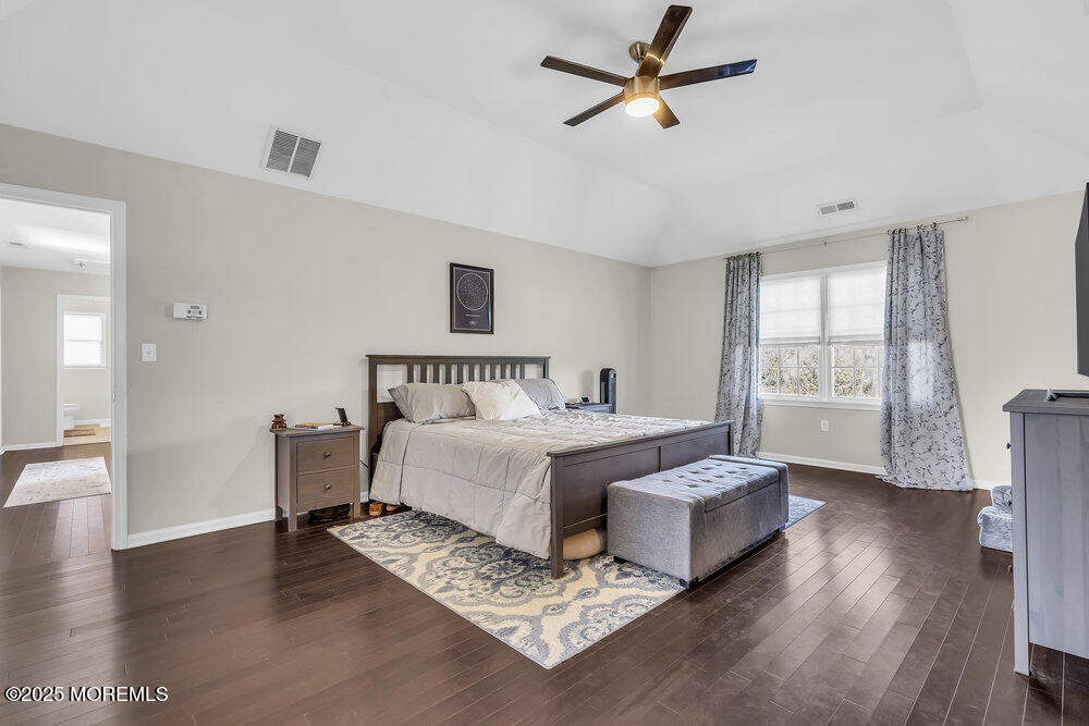 11 Cutter Court Cream Ridge, NJ 08514 - Photo 54 of 87 a spacious bedroom with a bed and wooden floor
