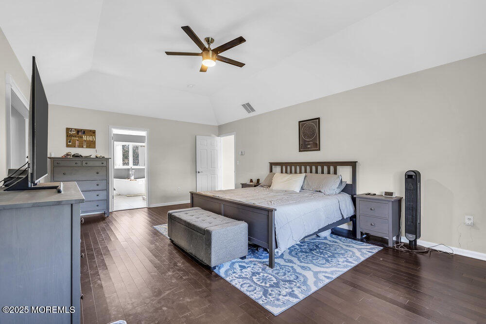 11 Cutter Court Cream Ridge, NJ 08514 - Photo 55 of 87 a spacious bedroom with a bed a couch and a chandelier