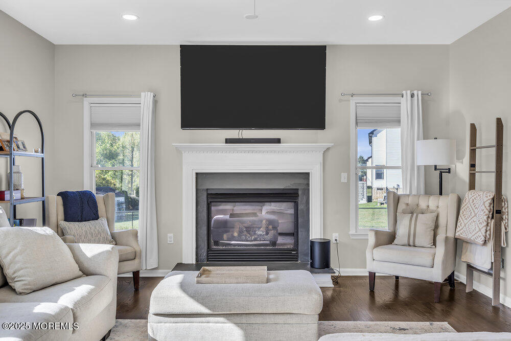 11 Cutter Court Cream Ridge, NJ 08514 - Photo 73 of 87 a living room with furniture a flat screen tv and a fireplace