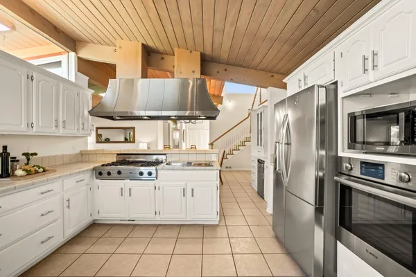 a kitchen with cabinets and appliances