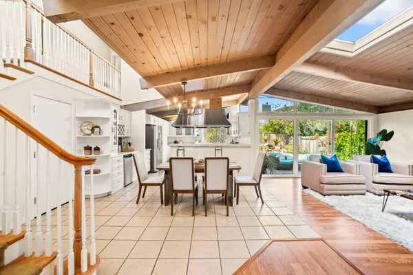 a dining room with furniture and a floor to ceiling window