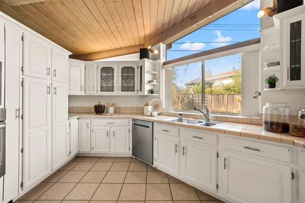 a kitchen with sink cabinets and window