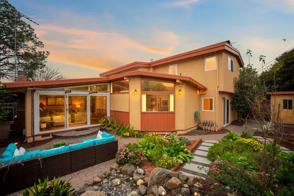 a backyard of a house with table and chairs