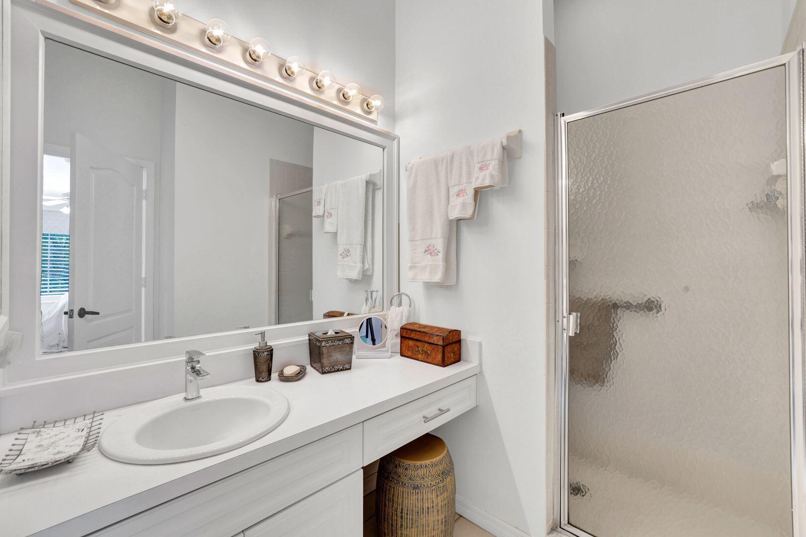 1006 Mainsail Drive, Unit 224 Naples, FL 34114 - Photo 15 of 30 a bathroom with a sink double vanity and a mirror