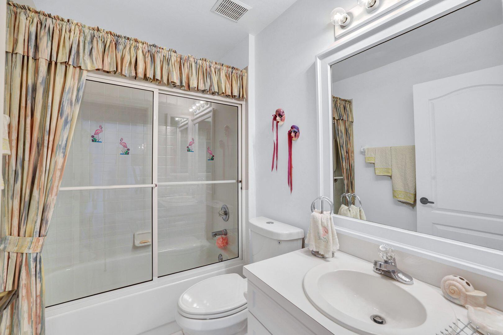 1006 Mainsail Drive, Unit 224 Naples, FL 34114 - Photo 18 of 30 a bathroom with a sink a toilet and shower
