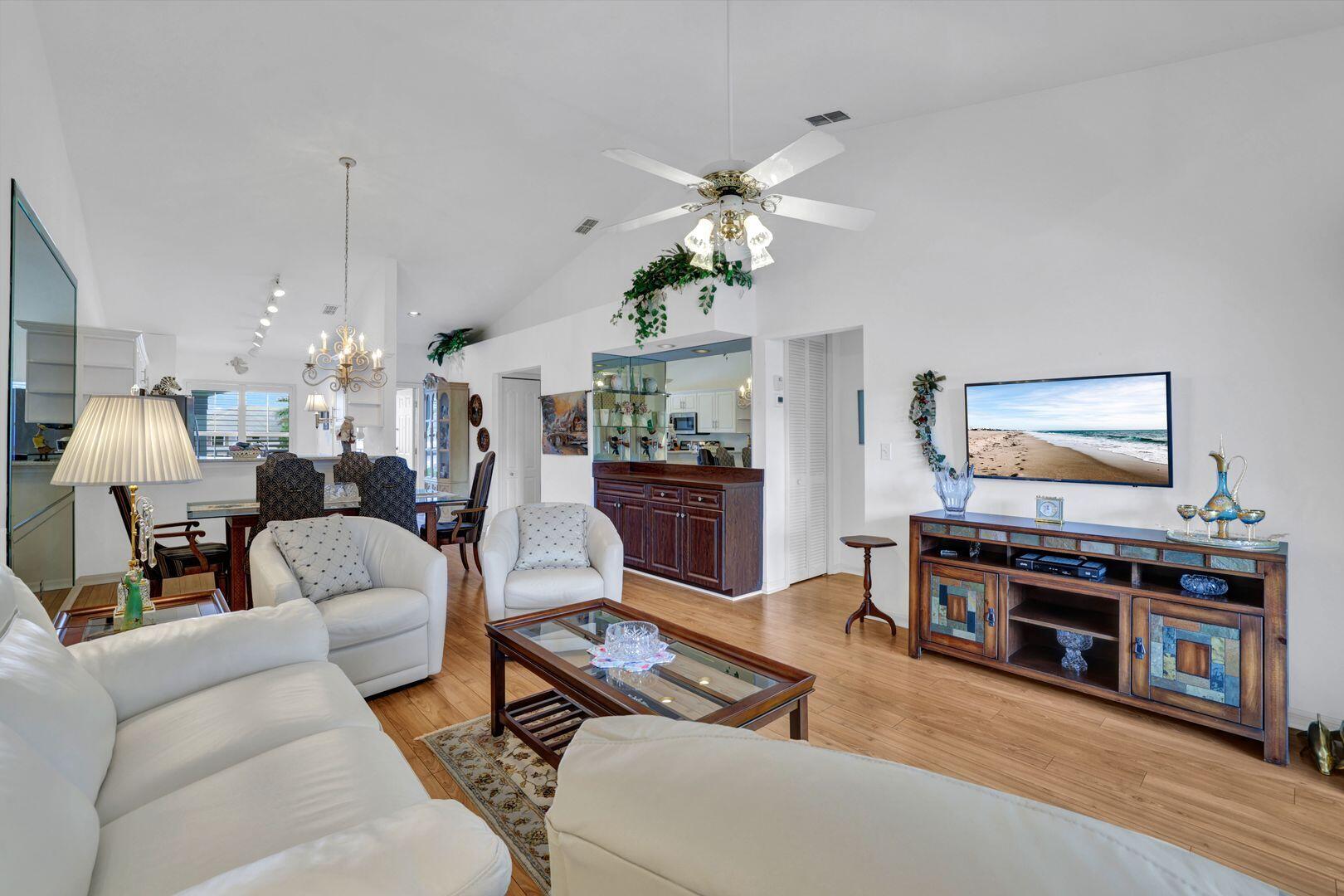 1006 Mainsail Drive, Unit 224 Naples, FL 34114 - Photo 4 of 30 a living room with furniture and a kitchen