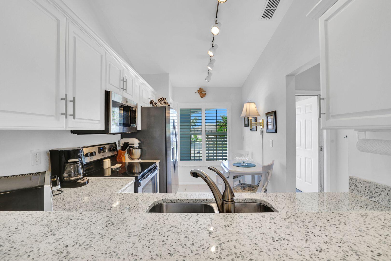 1006 Mainsail Drive, Unit 224 Naples, FL 34114 - Photo 7 of 30 a view of a kitchen and dining room