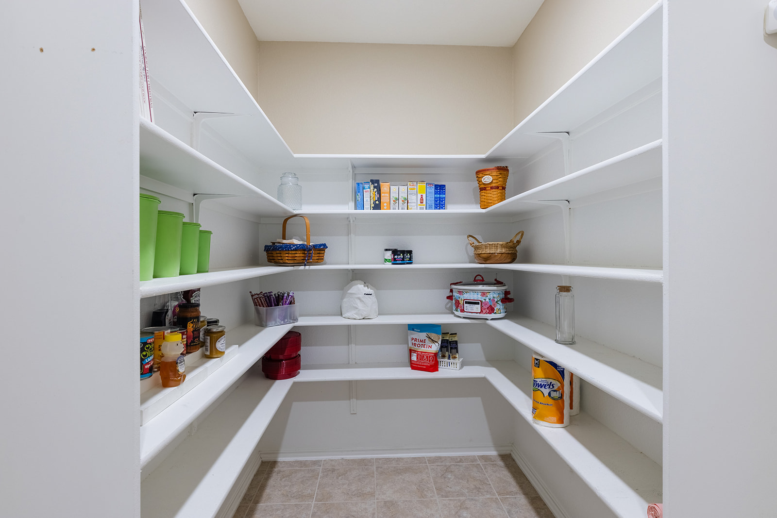 437 Sheepshank Drive Georgetown, TX 78633 - Photo 15 of 22 A dedicated open-concept walk-in pantry offers ample storage with wrap-around shelving for all your kitchen and food essentials.