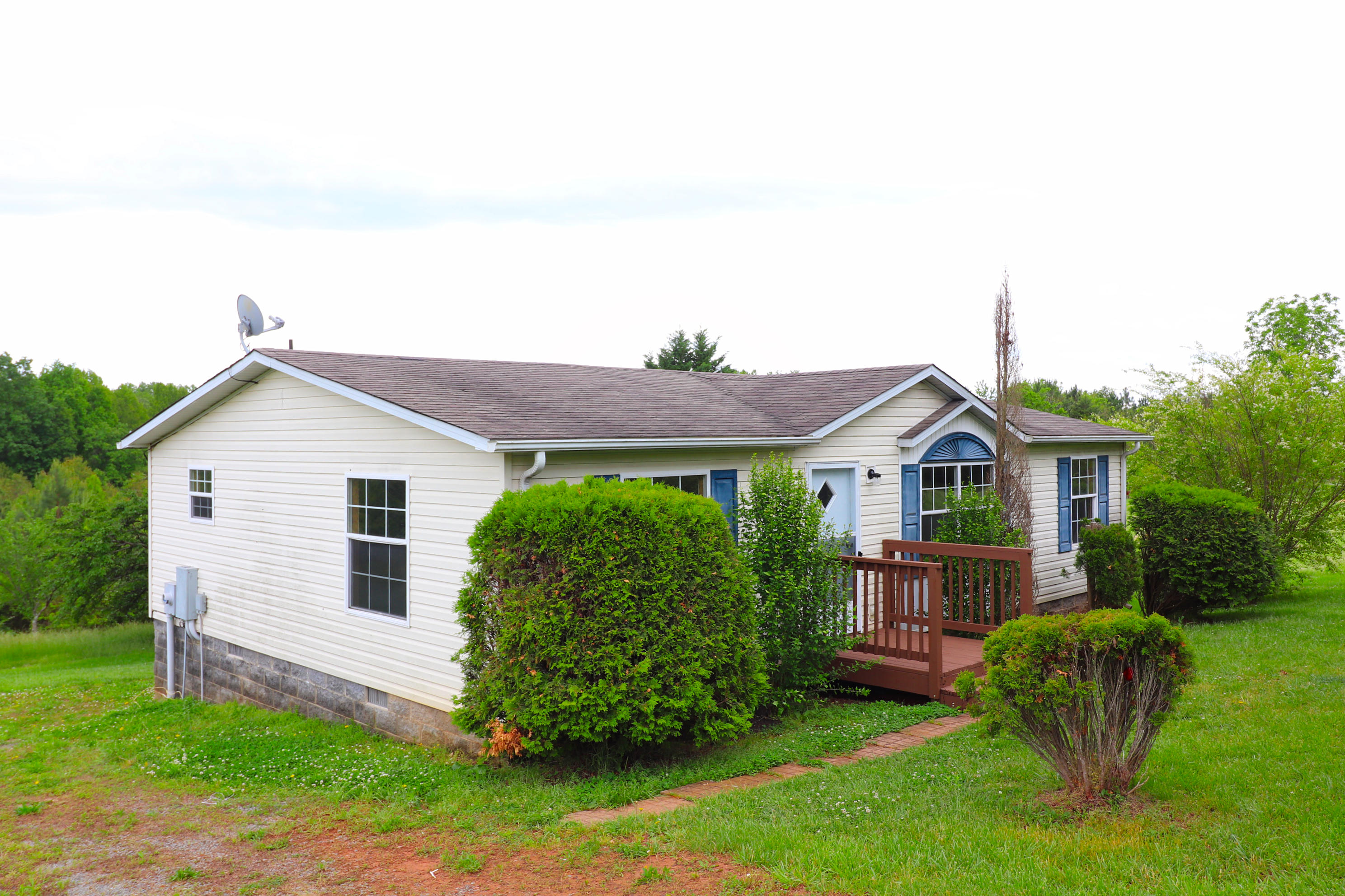 615 Edwards Road Penhook, VA 24137 - Photo 2 of 16 a view of a house with a yard and a garden