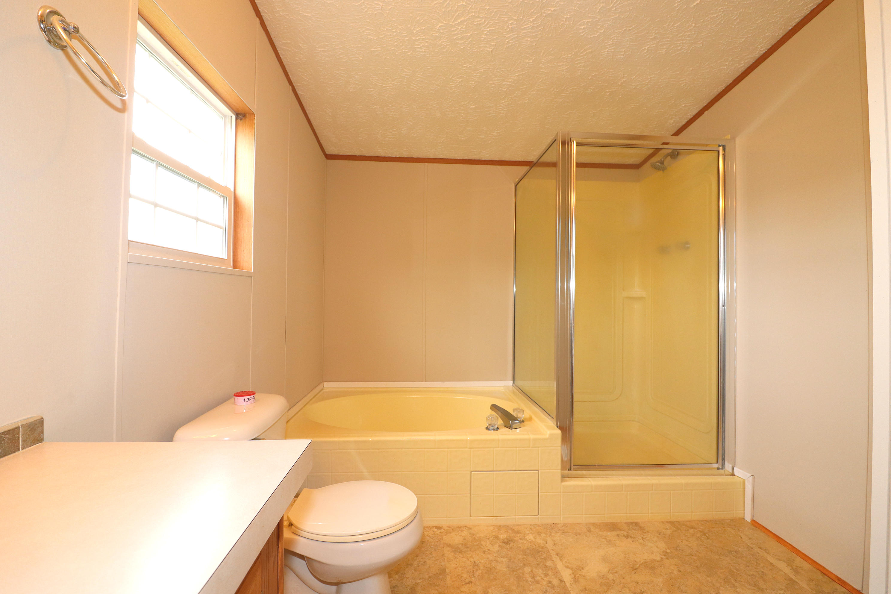 615 Edwards Road Penhook, VA 24137 - Photo 15 of 16 a bathroom with a granite countertop sink toilet and shower