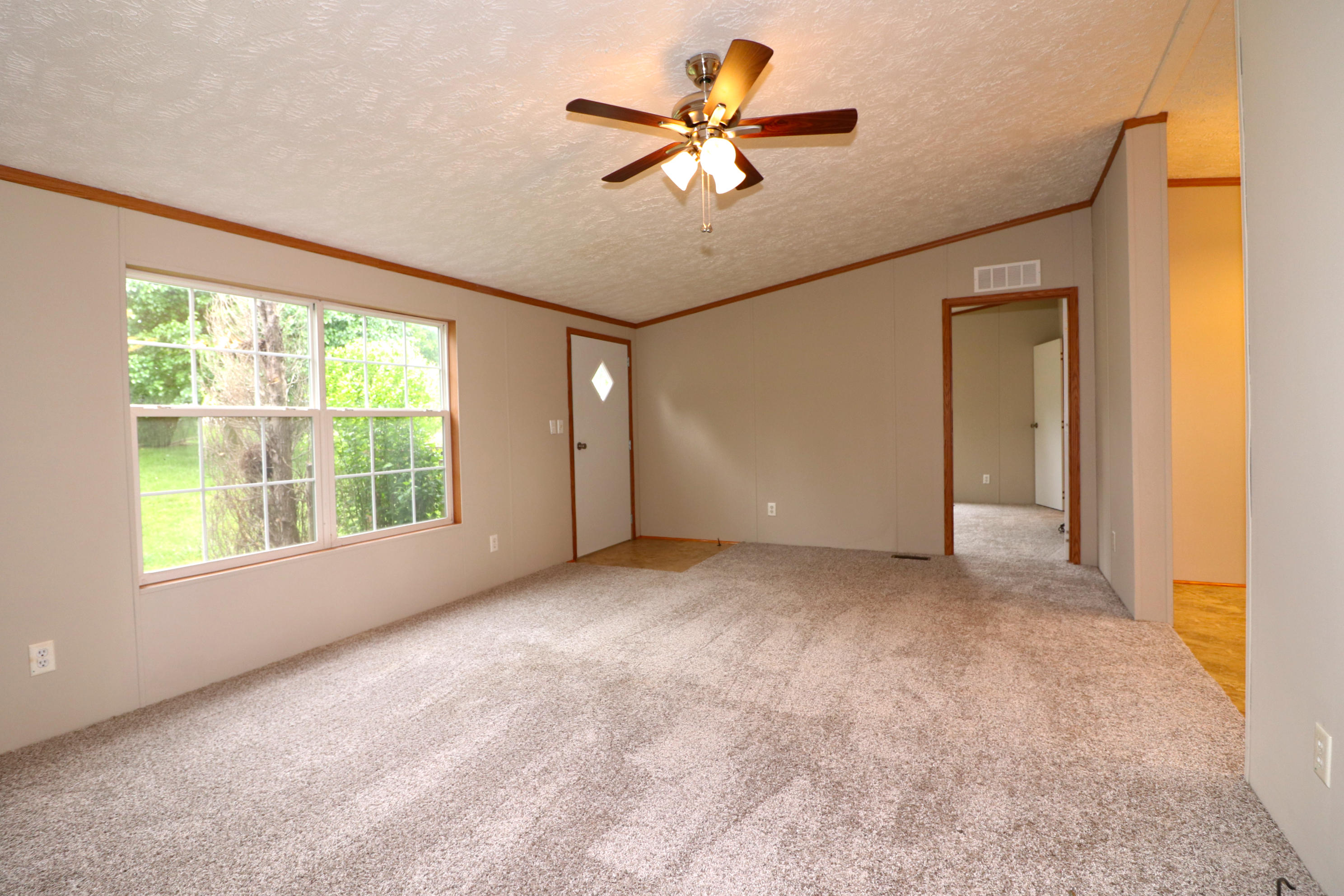 615 Edwards Road Penhook, VA 24137 - Photo 5 of 16 a view of a livingroom with a ceiling fan and window