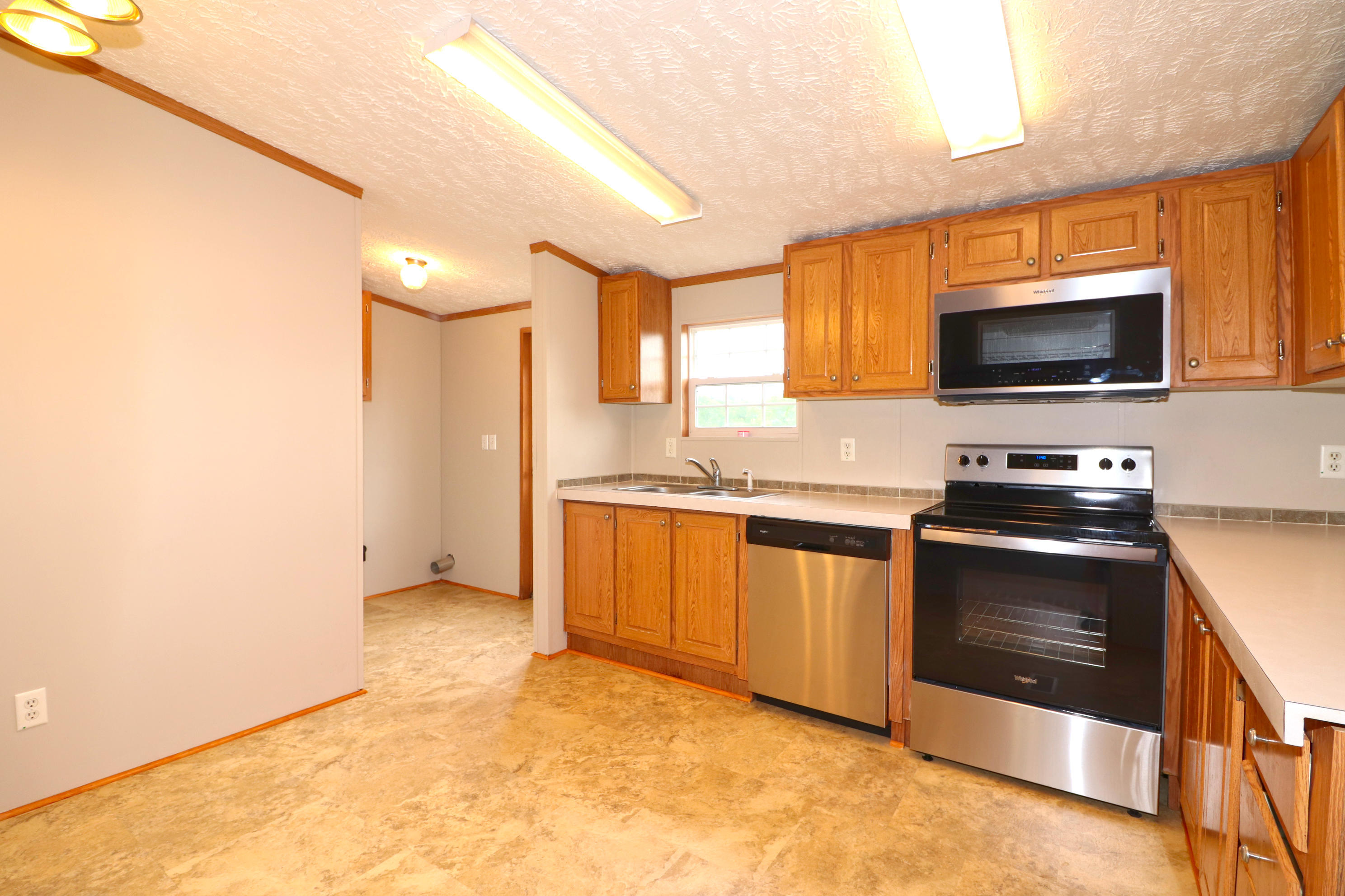 615 Edwards Road Penhook, VA 24137 - Photo 8 of 16 a kitchen with stainless steel appliances a stove a microwave and a sink