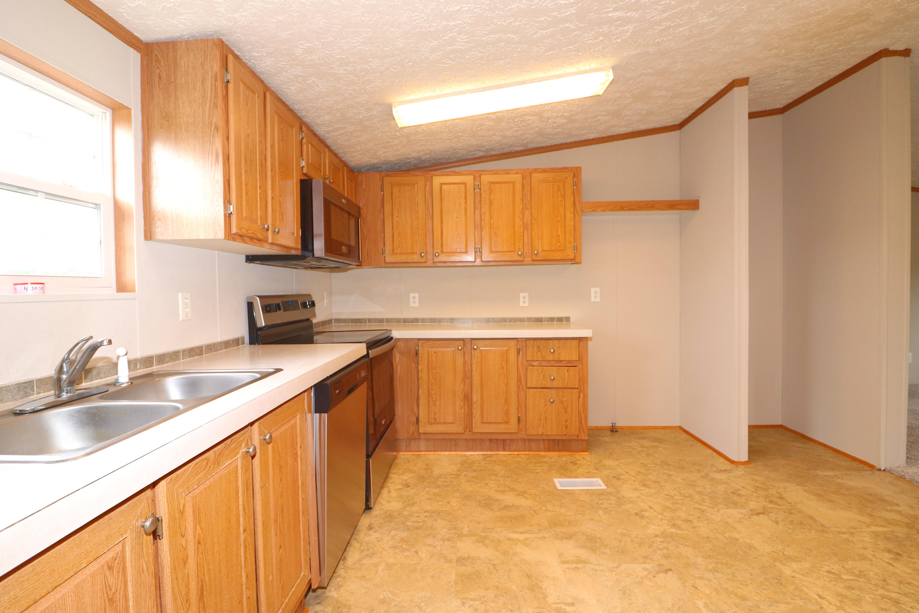 615 Edwards Road Penhook, VA 24137 - Photo 9 of 16 a kitchen with a sink stove and cabinets