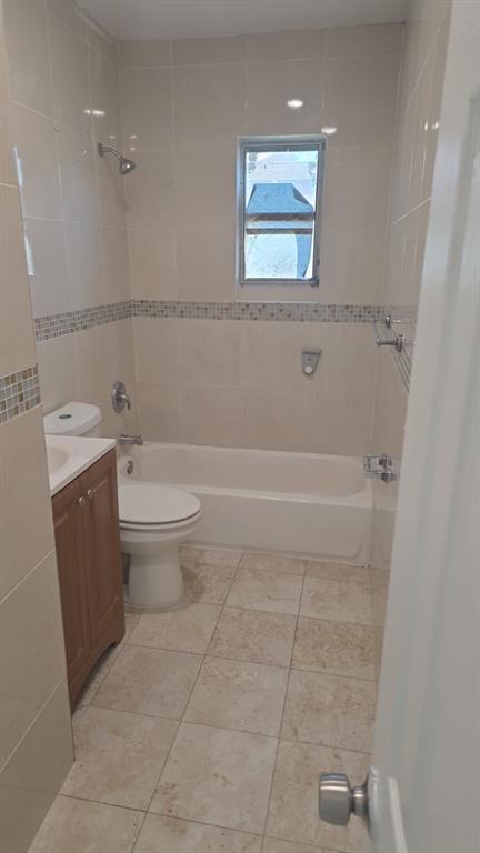 5241 Mayo Street Hollywood, FL 33021 - Photo 5 of 15 a bathroom with a toilet a sink and mirror