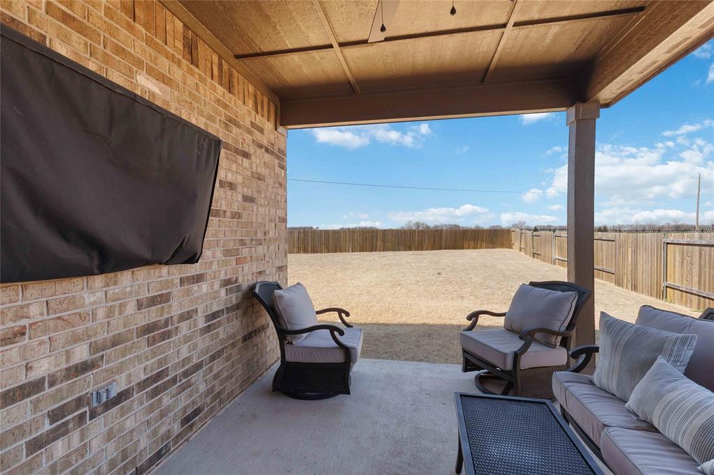1012 Calhoun Drive Anna, TX 75409 - Photo 36 of 39 Covered patio featuring a concrete slab and a brick exterior wall