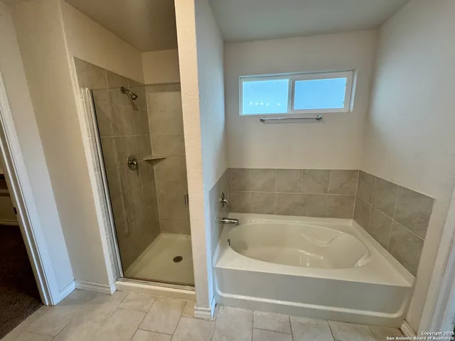 a bath tub sitting next to a shower