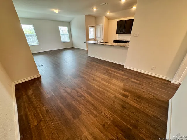 a view of a kitchen with a sink and a stove top oven