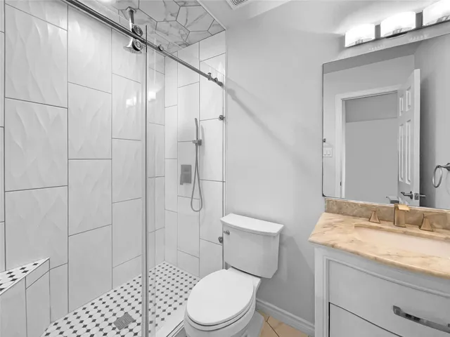 a white toilet sitting next to a bathroom sink